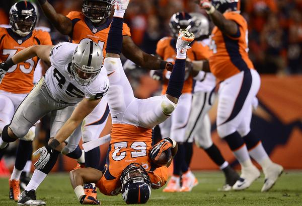 DENVER, CO - SEPTEMBER 23: Denver Broncos outside linebacker Wesley Woodyard (52) falls over after recovering a fumbled that was called back in the second quarter. The Denver Broncos took on the Oakland Raiders at Sports Authority Field at Mile High in Denver on September 23, 2013. (Photo by AAron Ontiveroz/The Denver Post)
